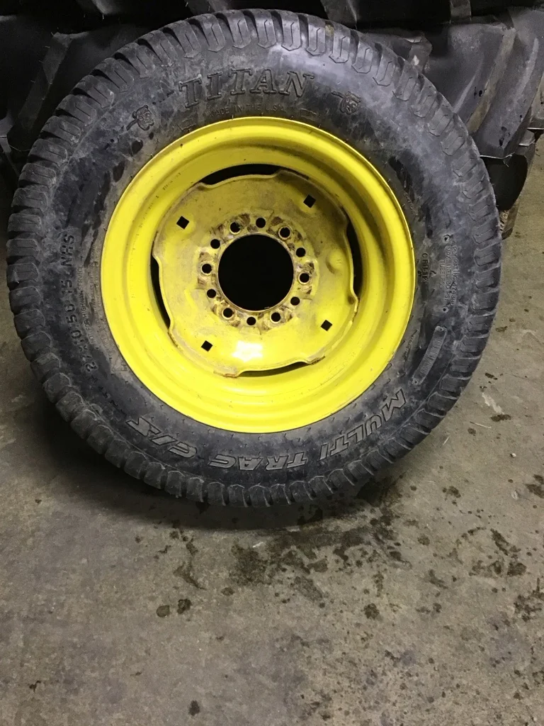 Used 27x10.50-15/4 Titan Multi Trac C/S TL R-3 65-70% on 8 x 15 6-6-4.62 Implement Yellow Wheel