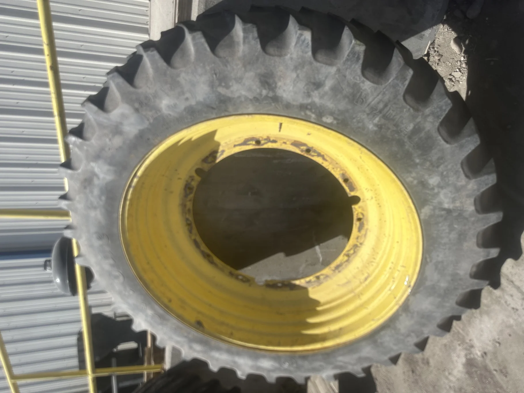 Used 40% 14.9R46 Firestone Radial All Traction 23 R-1 (145B) TL on a 13 x 46 JD Yellow 12 Bol
