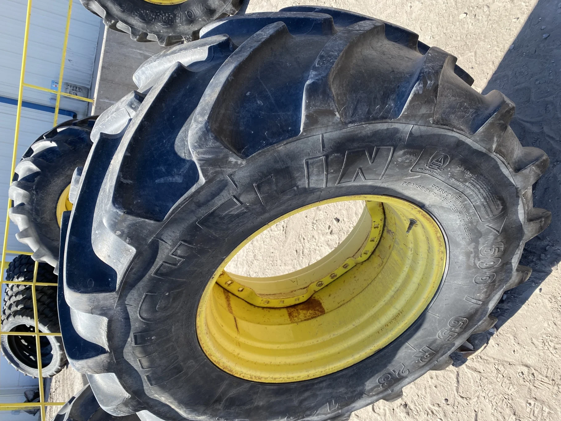 Used 67% 600/65R28 Michelin XM28 TL on a 18 x 28 JD Yellow Waffle Wheel (3 Bolt) 4" offset   (