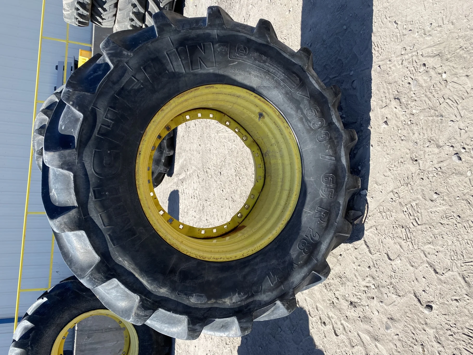 Used 67% 600/65R28 Michelin XM28 TL on a 18 x 28 JD Yellow Waffle Wheel (3 Bolt) 4" offset   ( image 2