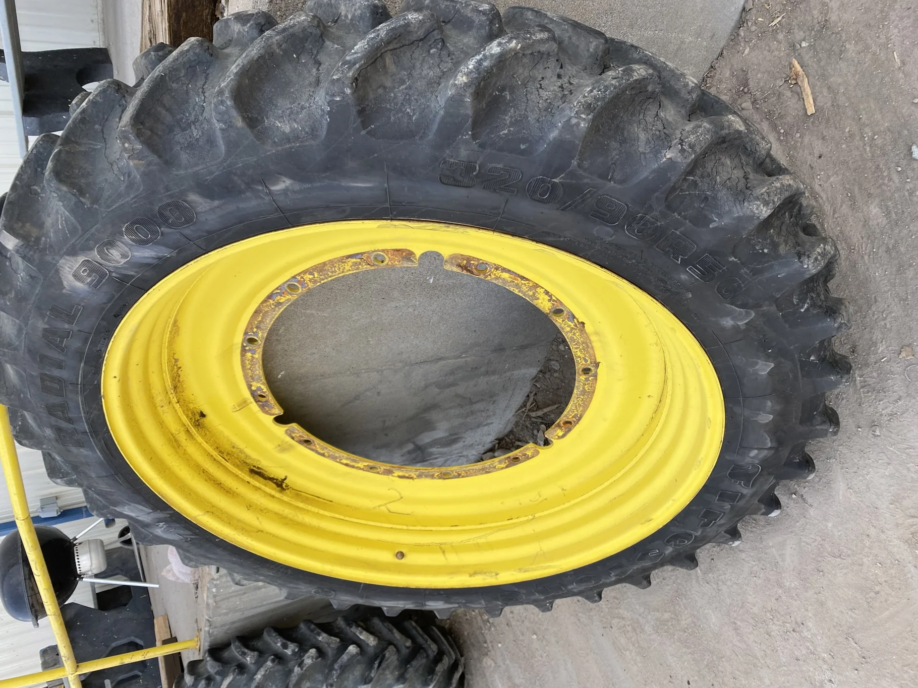 Used 65% 320/90R50 Firestone Radial 9000 R-1W (148B) TL on a 10 x 50 John Deere Yellow 12 Bolt Stub