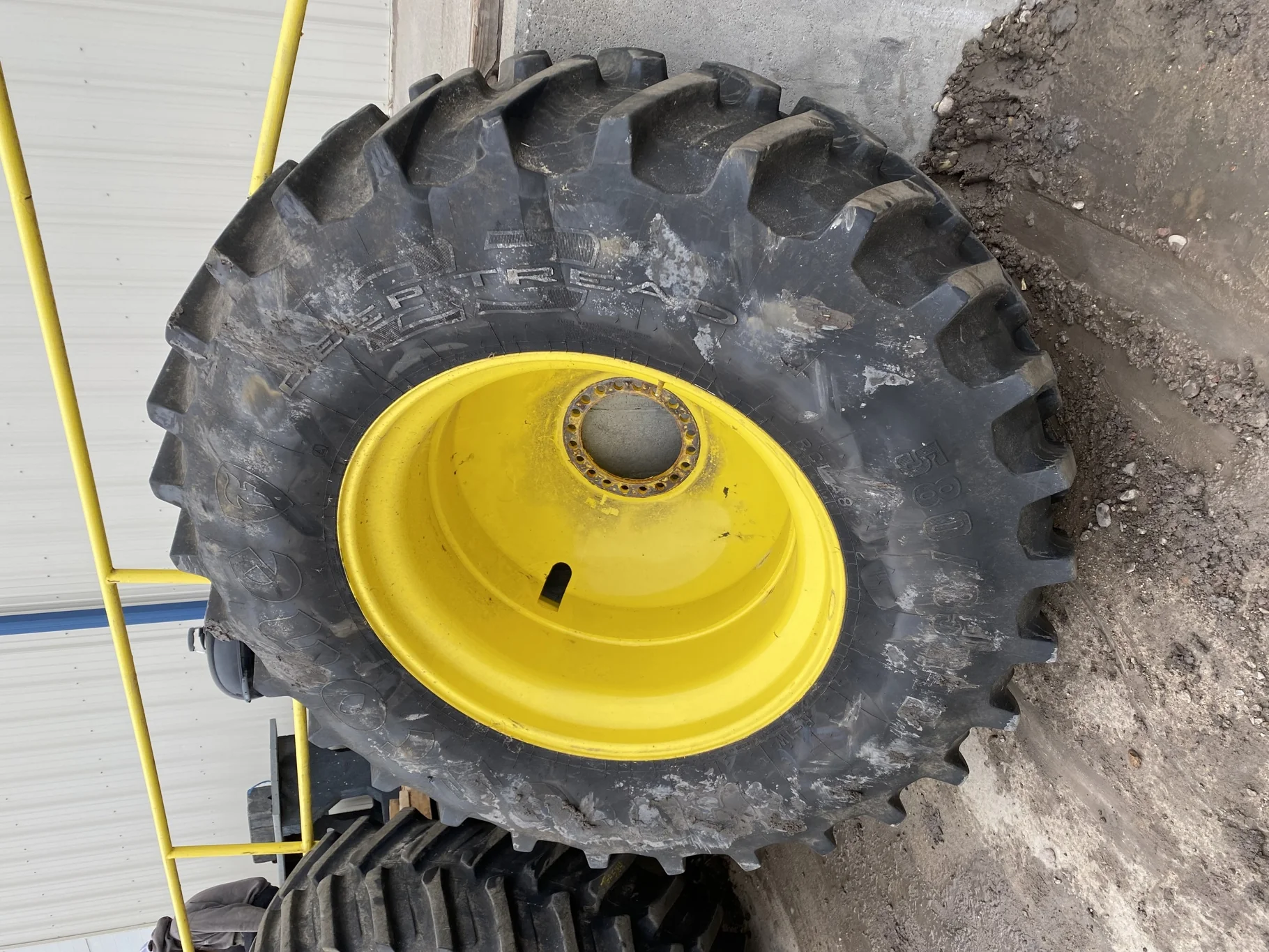 Used 85% 580/85R42 Firestone Radial Deep Tread 23 R-1W (166B) TL on a 18 x 42 JD Yellow 20 B Inside