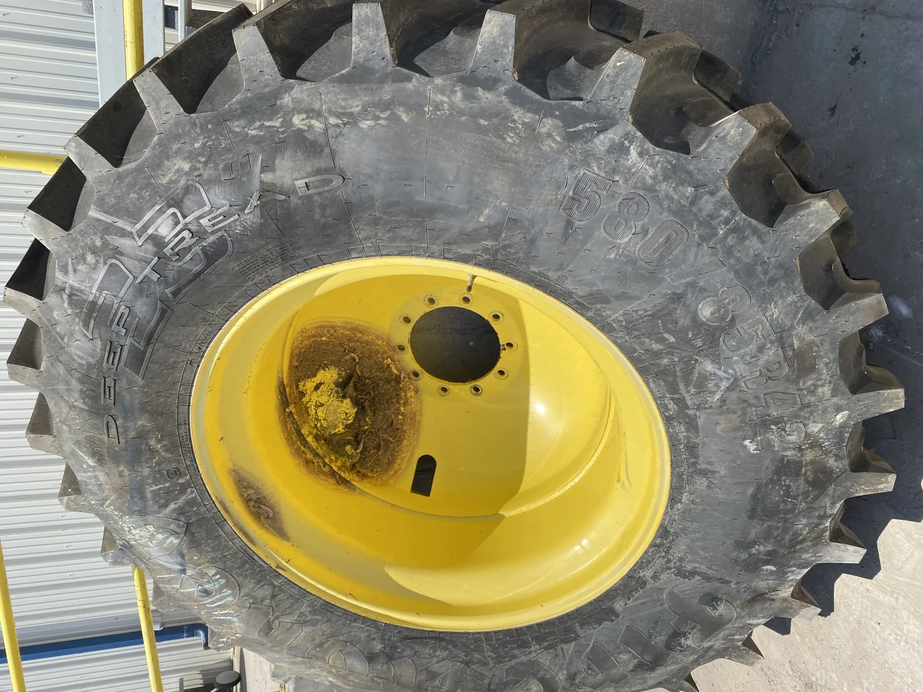 Used 70% 580/85R42 Firestone Radial Deep Tread 23 R-1W (166B )TL on a 18 x 42 JD Yellow 10 Bolt