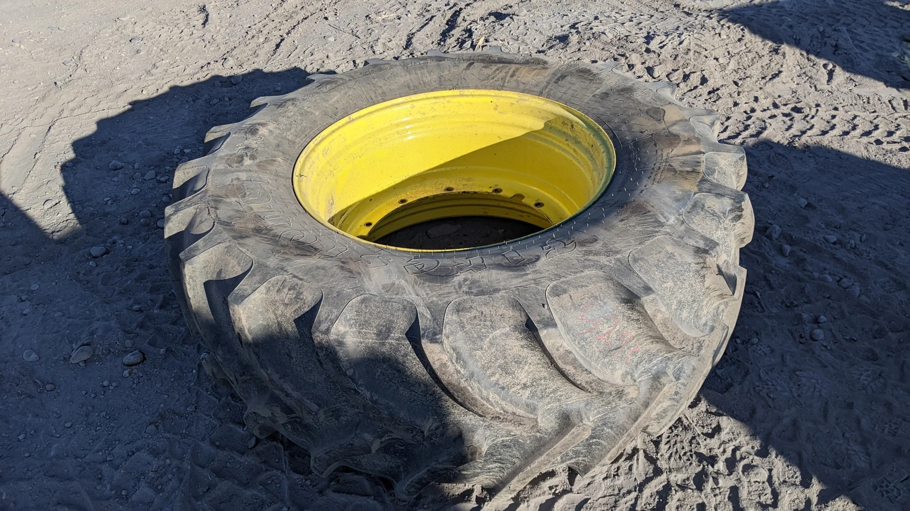 Used 87% 710/70R42 Firestone Maxi Traction R-1W 168DA8 TL on a 23 x 42 JD Yellow 12 Bolt (.945