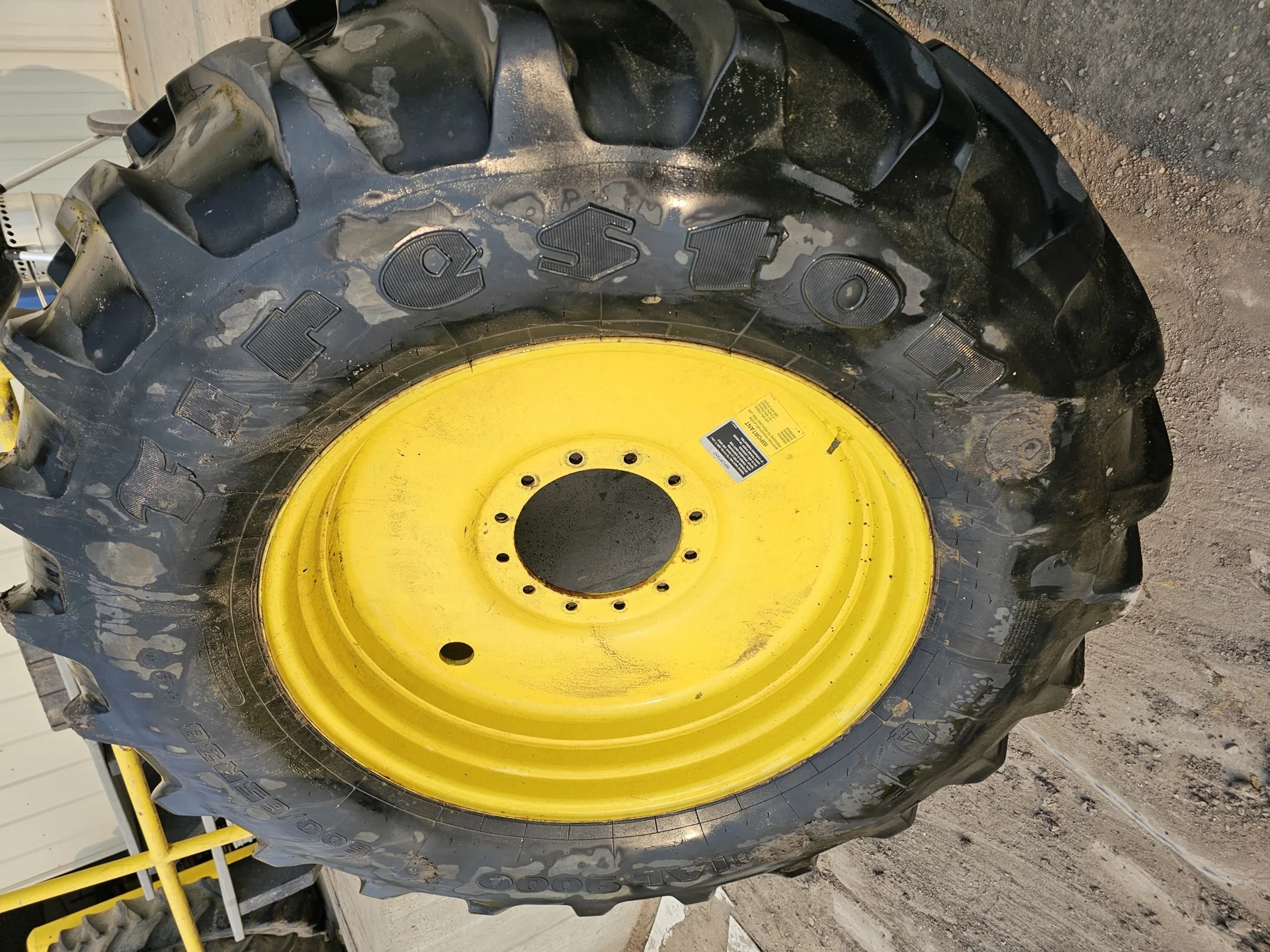 Used 85% 600/65R38 Firestone 9000 65 R-1W 153D TL on a 18 x 38 12-13.976 JD Yellow Sprayer
