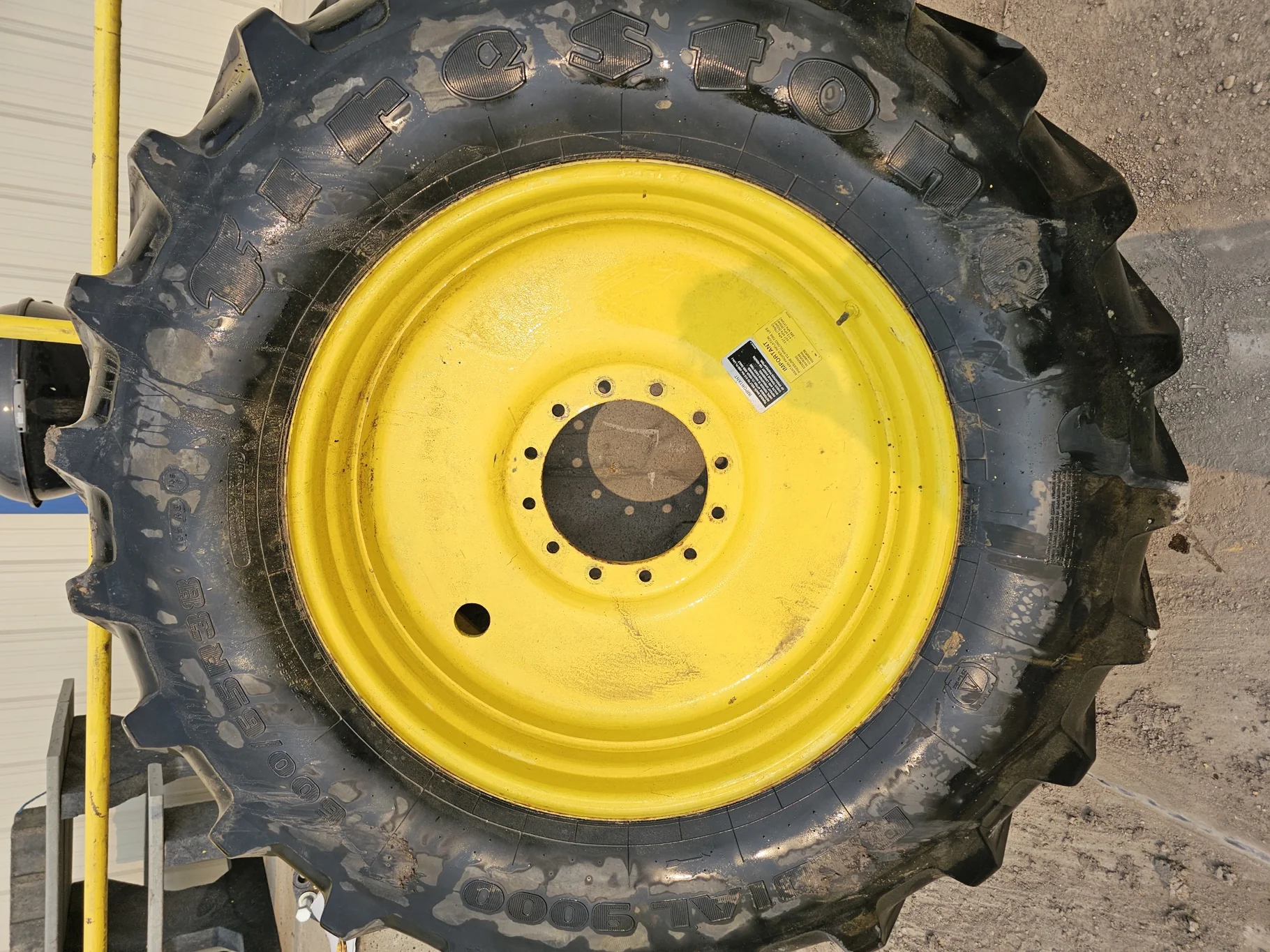 Used 85% 600/65R38 Firestone 9000 65 R-1W 153D TL on a 18 x 38 12-13.976 JD Yellow Sprayer image 2