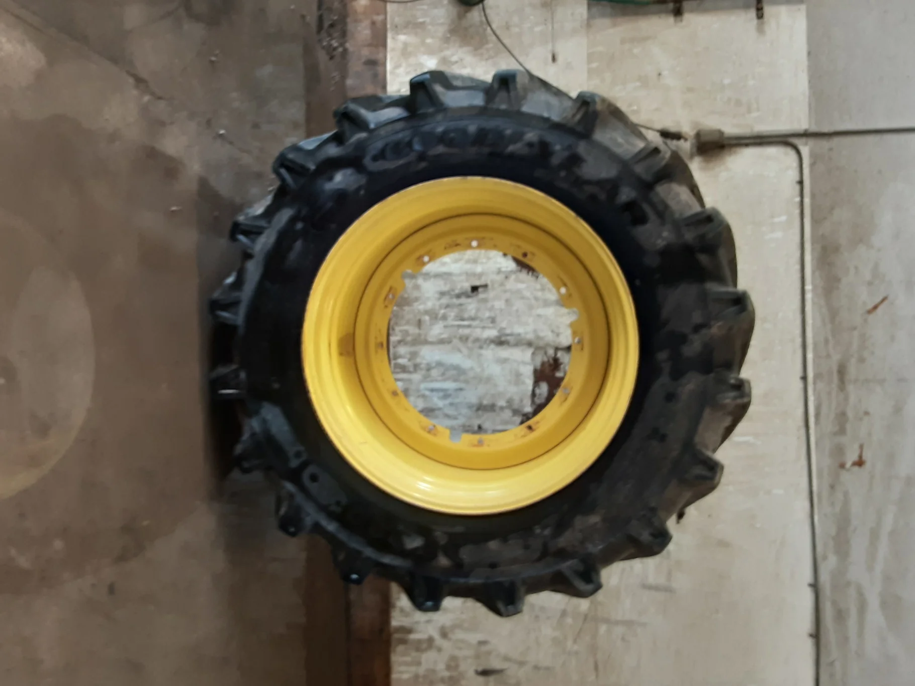Used 70% LSW1100/45R46 Goodyear DT930 R-1W (181D) TL on a 38 x 46 JD Yellow 12 Bolt Stub Disc
