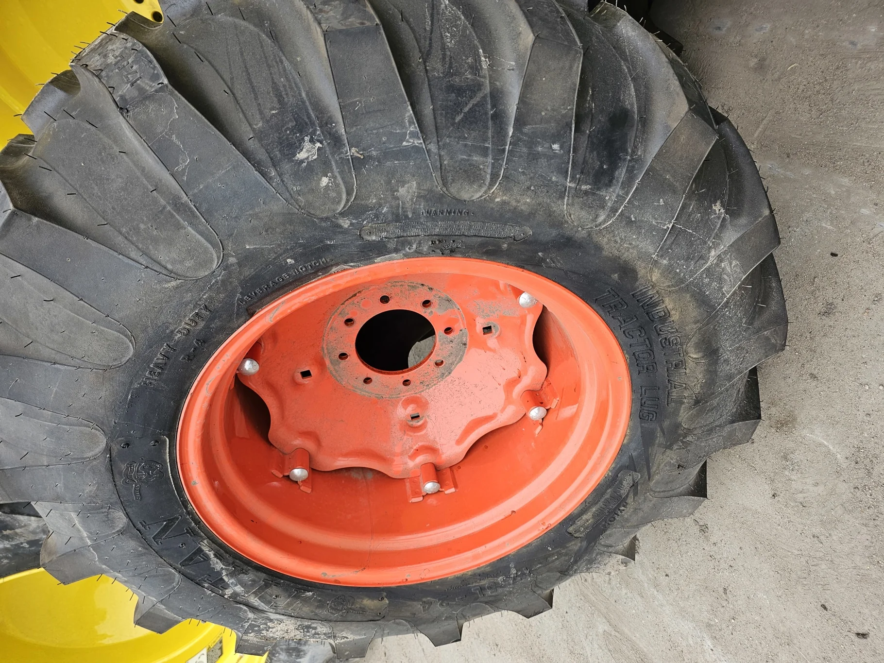 Take Off 17.5L-24 Titan Industrial Tractor Lug R-4 D(8Ply) TL on a 15 X 24 Kubota Orange 6 Loop Whee