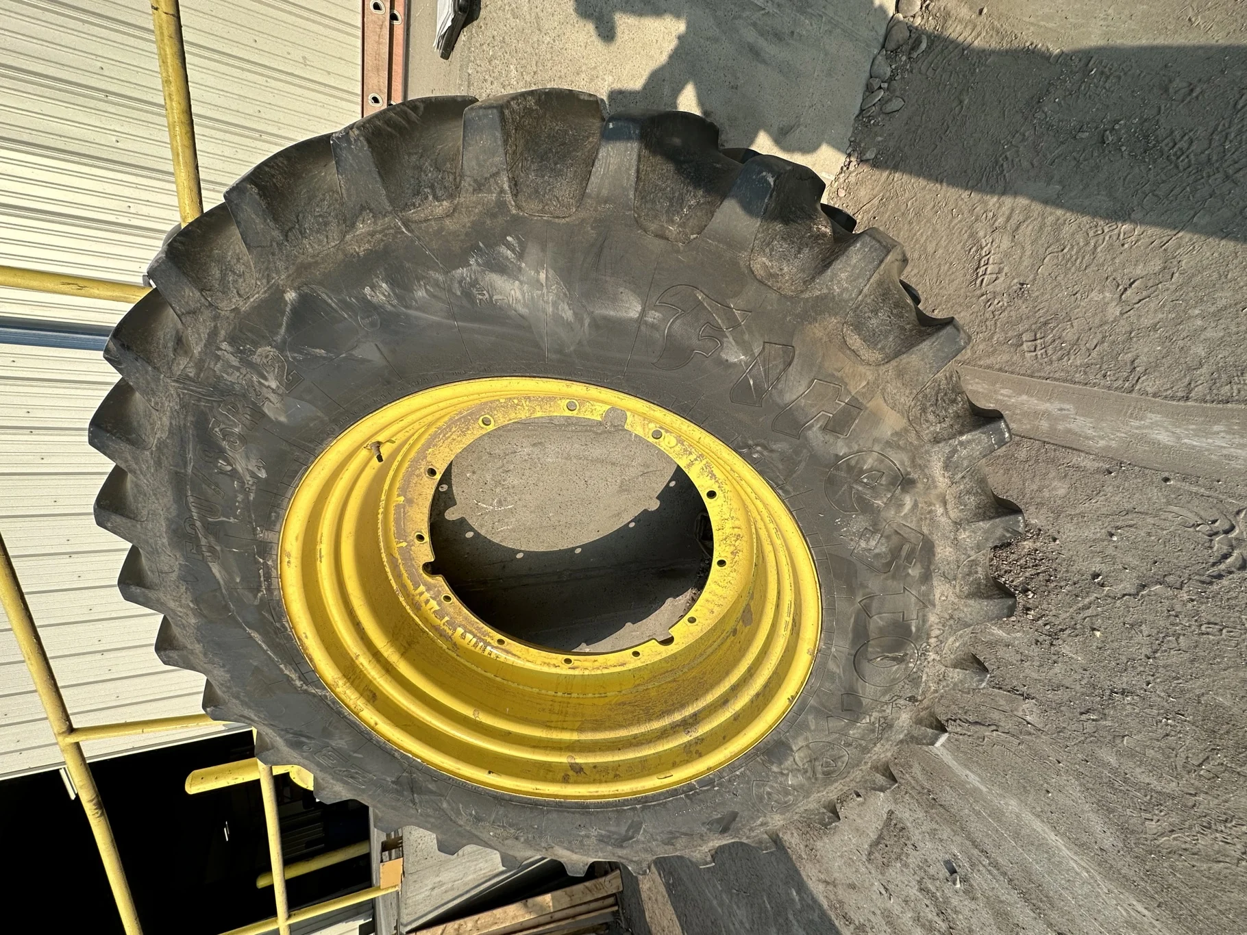 Used 85% 520/85R42 Firestone Radial Deep Tread 23 R-1W 157B TL on 18 x 42 JD Stub Disc - Fair Condi