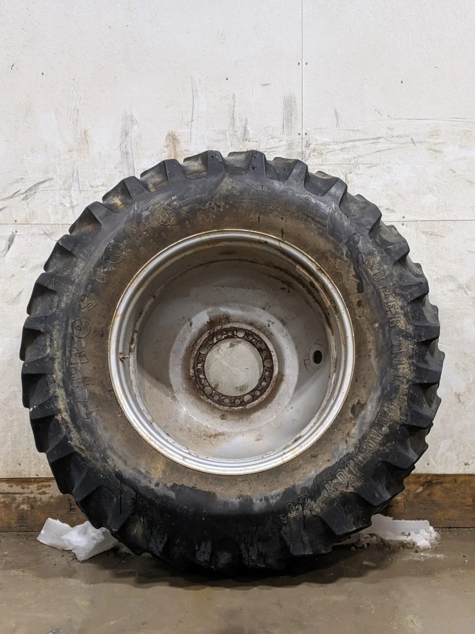 Used 45% 20.8-38 Firestone Radial Deep Tread 23 (155B) R-1W on a 18 x 38 Case Silver 20 Bolt Dolly D