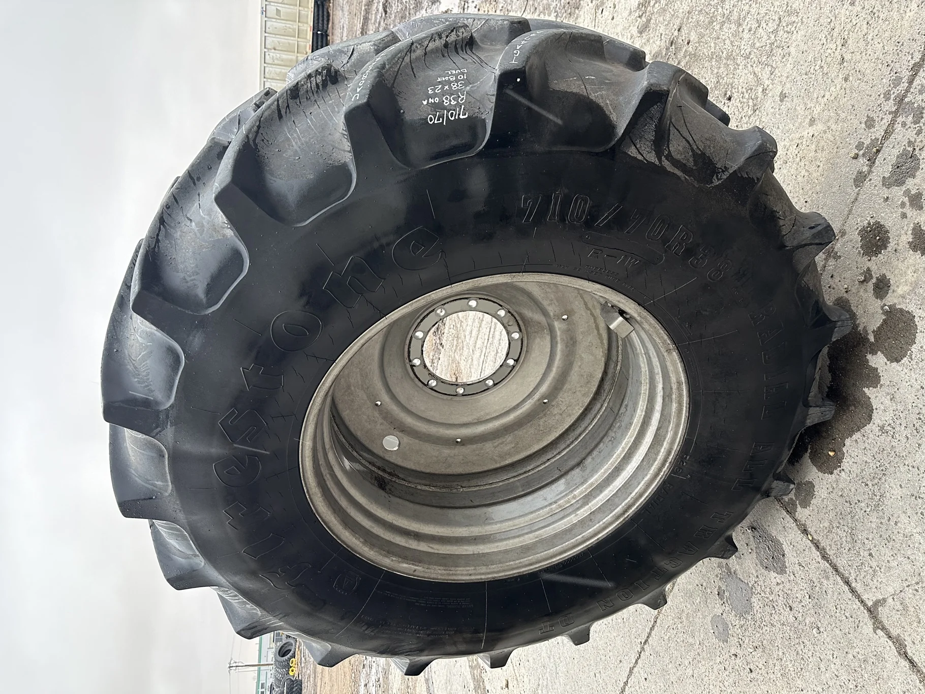 Used 75% 710/70R38 Firestone Radial All Traction DT R-1W (166B) TL on a 23 x 38 CIH Silver 10 Bolt