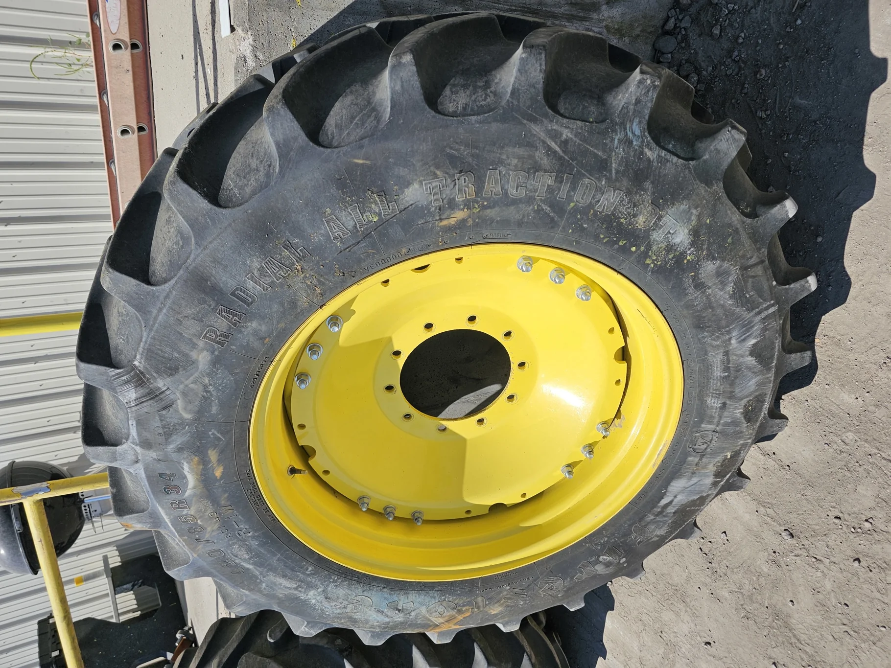 Used 79% 420/85R34 Firestone Radial All Traction DT R-1W 147B TL on a 15 x 34 JD Yellow Waffle
