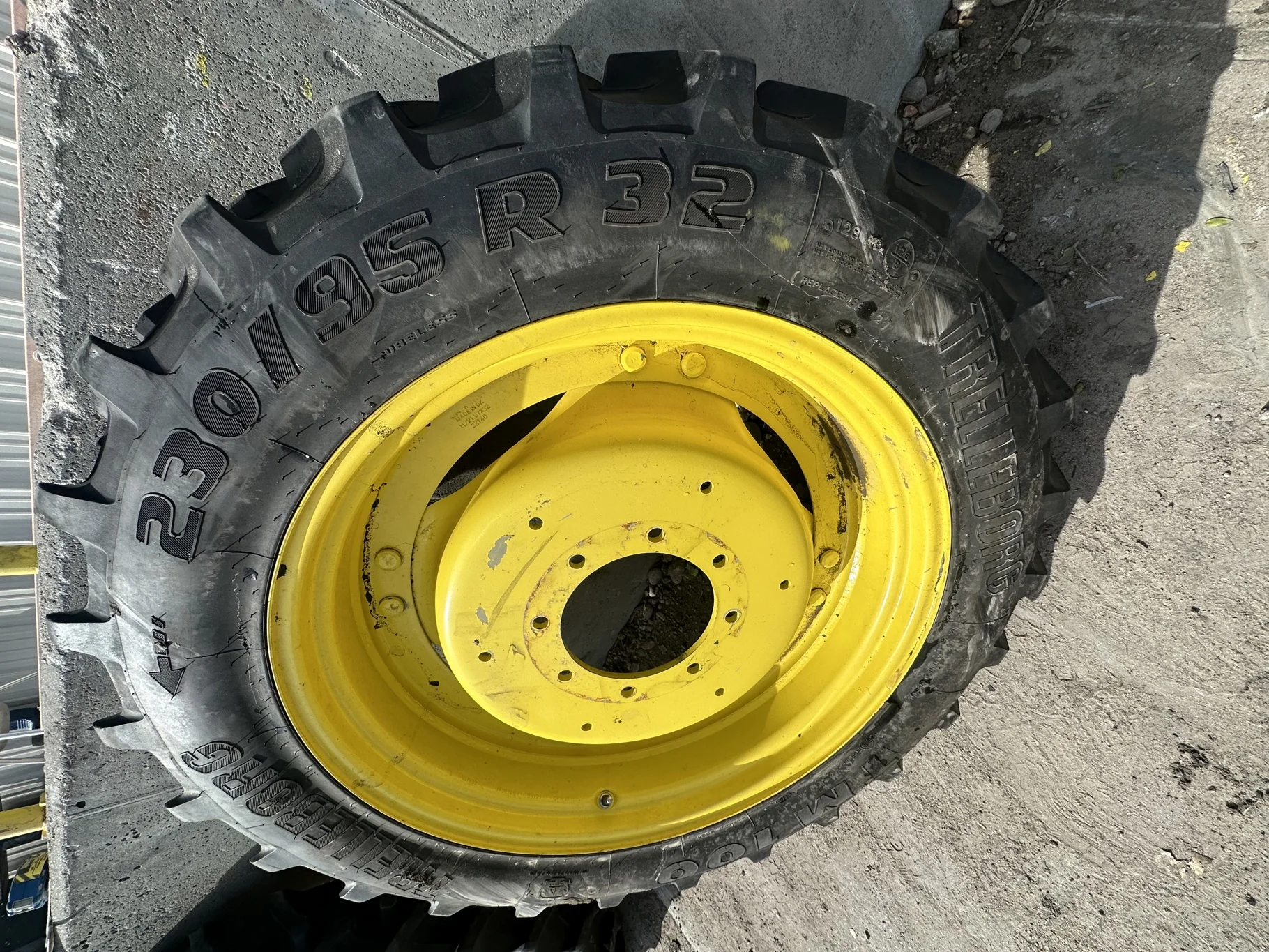 Used 80% 230/95R32 Trelleborg TM100 R-1 128A8 TL on a 7 x 32 JD Yellow 8 Bolt 2 Bolt Waffle R