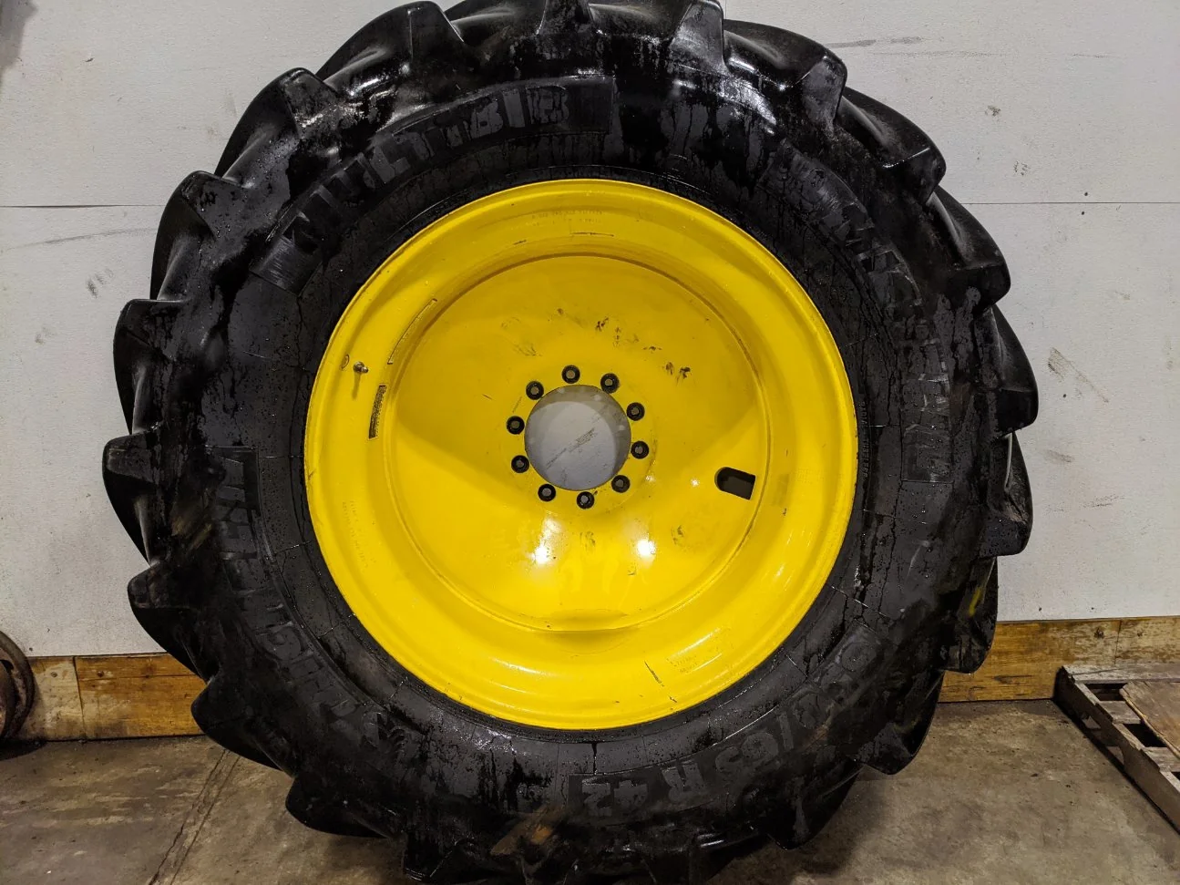 Used 90% 650/65R42 Michelin MachXBib (173A8/B) TL on a 18 x 42 JD Yellow 10 Bolt Inside Dolly