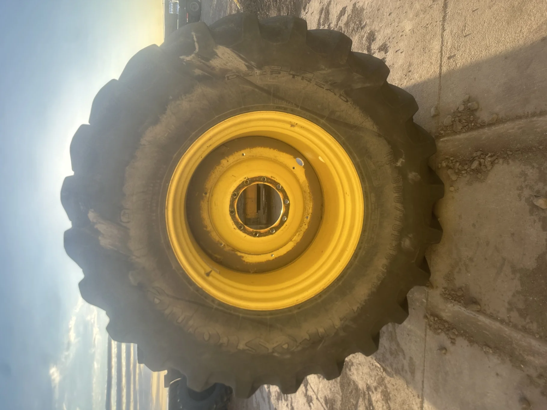 Used 85% IF800/70R38 Firestone Deep Tread  23 R-1W 173D TL on a 27 x 38 JD Yellow 10 Bolt Combine Wh