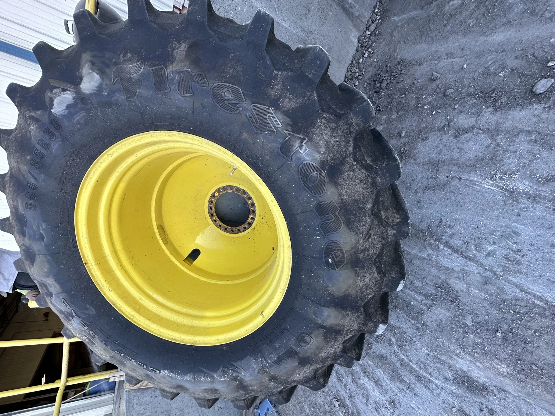 Used 87% 650/85R38 Firestone Radial Deep Tread 23 R-1W 173B TL on 23 x 38 John Deere Yellow 20 Bolt