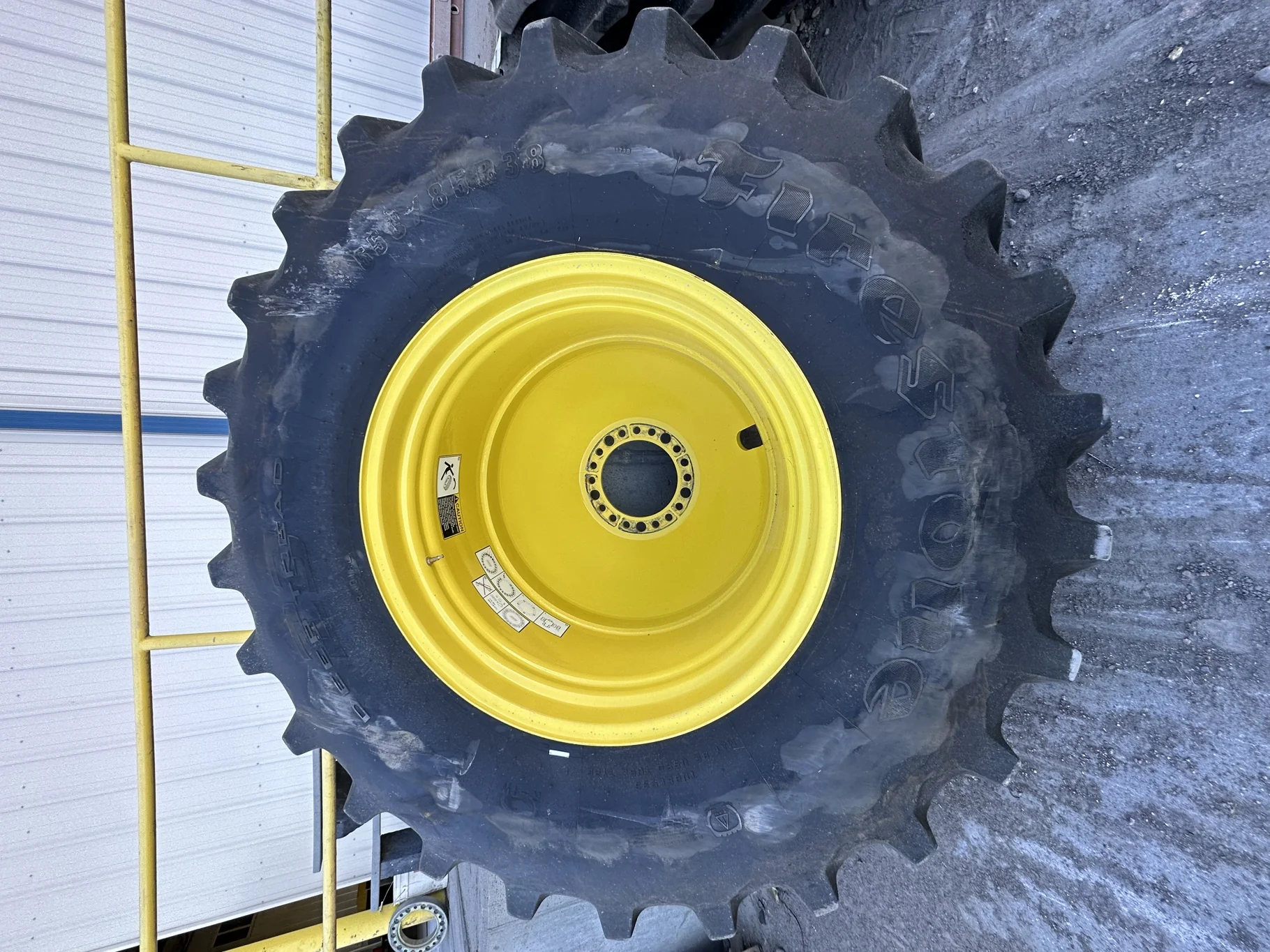 Used 87% 650/85R38 Firestone Radial Deep Tread 23 R-1W 173B TL on a 23 X 38 John Deere Yellow 20 Bol image 2