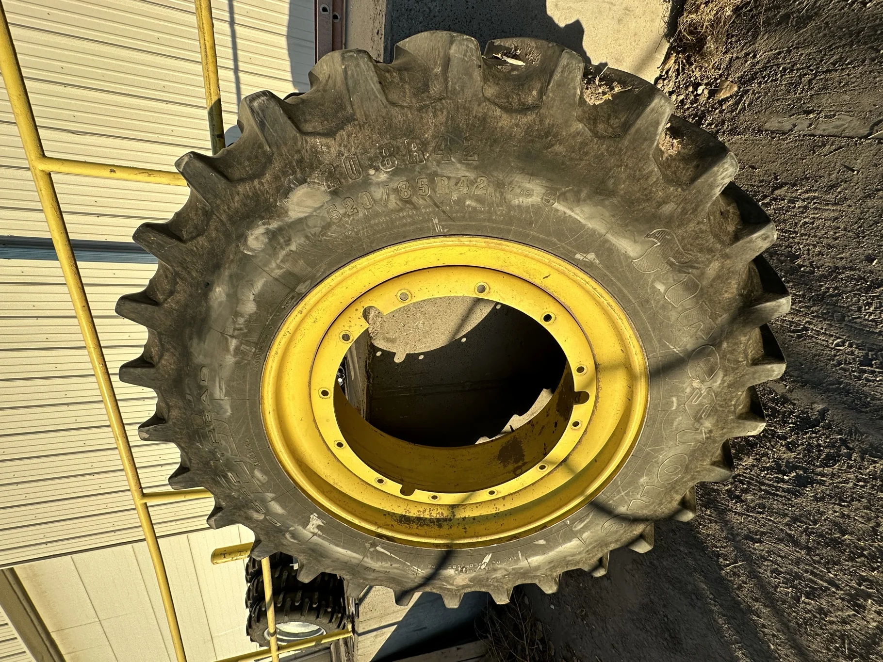 Used 65% 520/85R42 Firestone Radial Deep Tread 23 R-1W (157B) TL on 18 x 42 John Deere Yellow 12 Bo