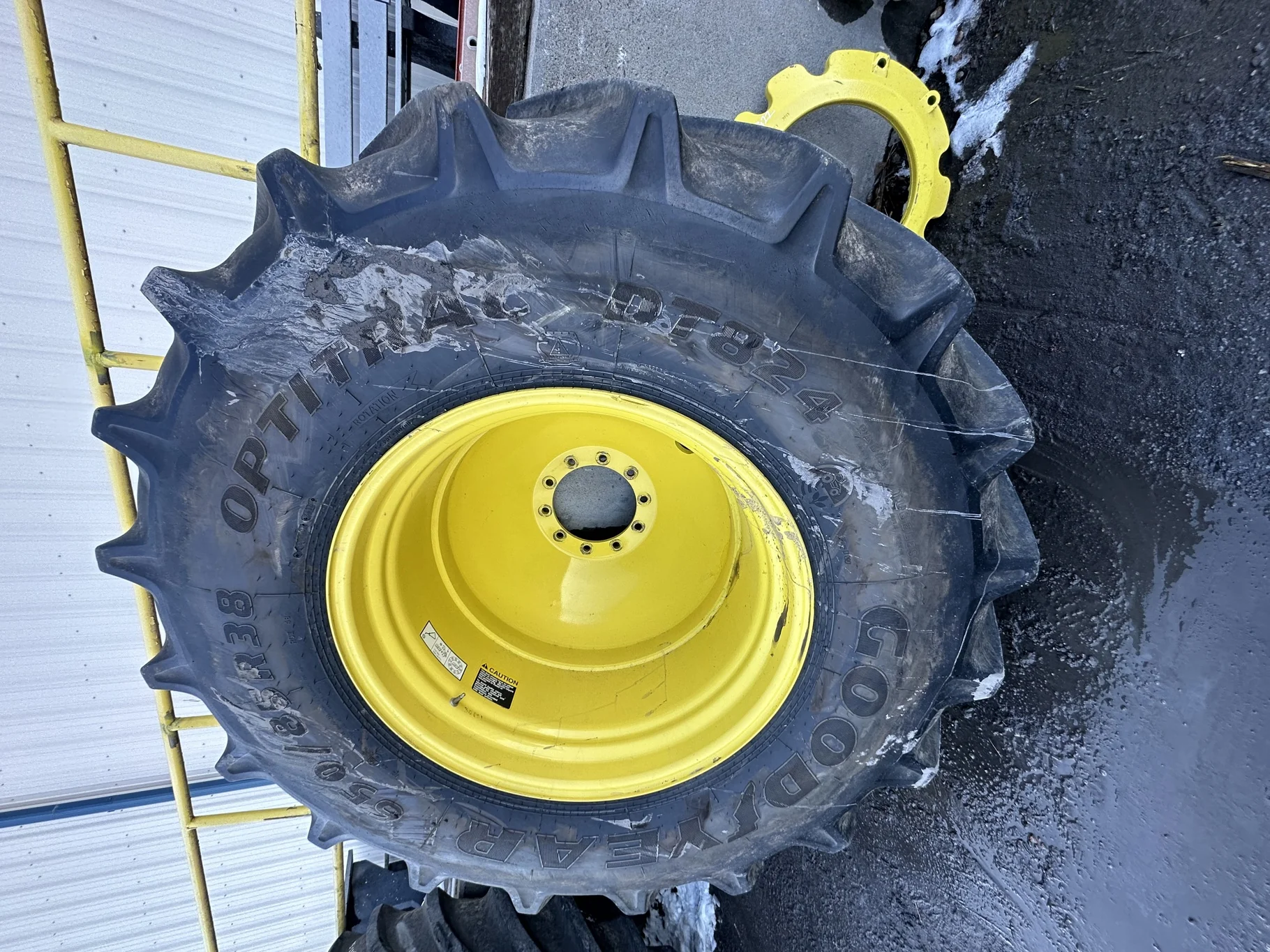 Used 90% 650/85R38 Goodyear Optitrac 173D R-1W TL on a 23 x 38 JD Yellow 10 Bolt Outside Dolly