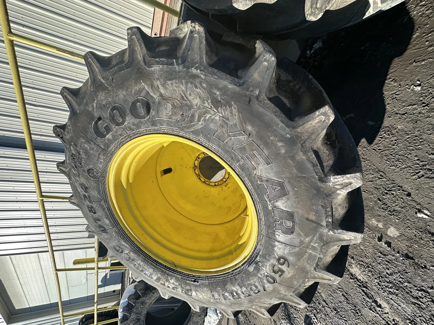 Used 90% 650/85R38 Goodyear Optitrac 173D R-1W TL on a 23 x 38 JD Yellow 10 Bolt Inside Dolly