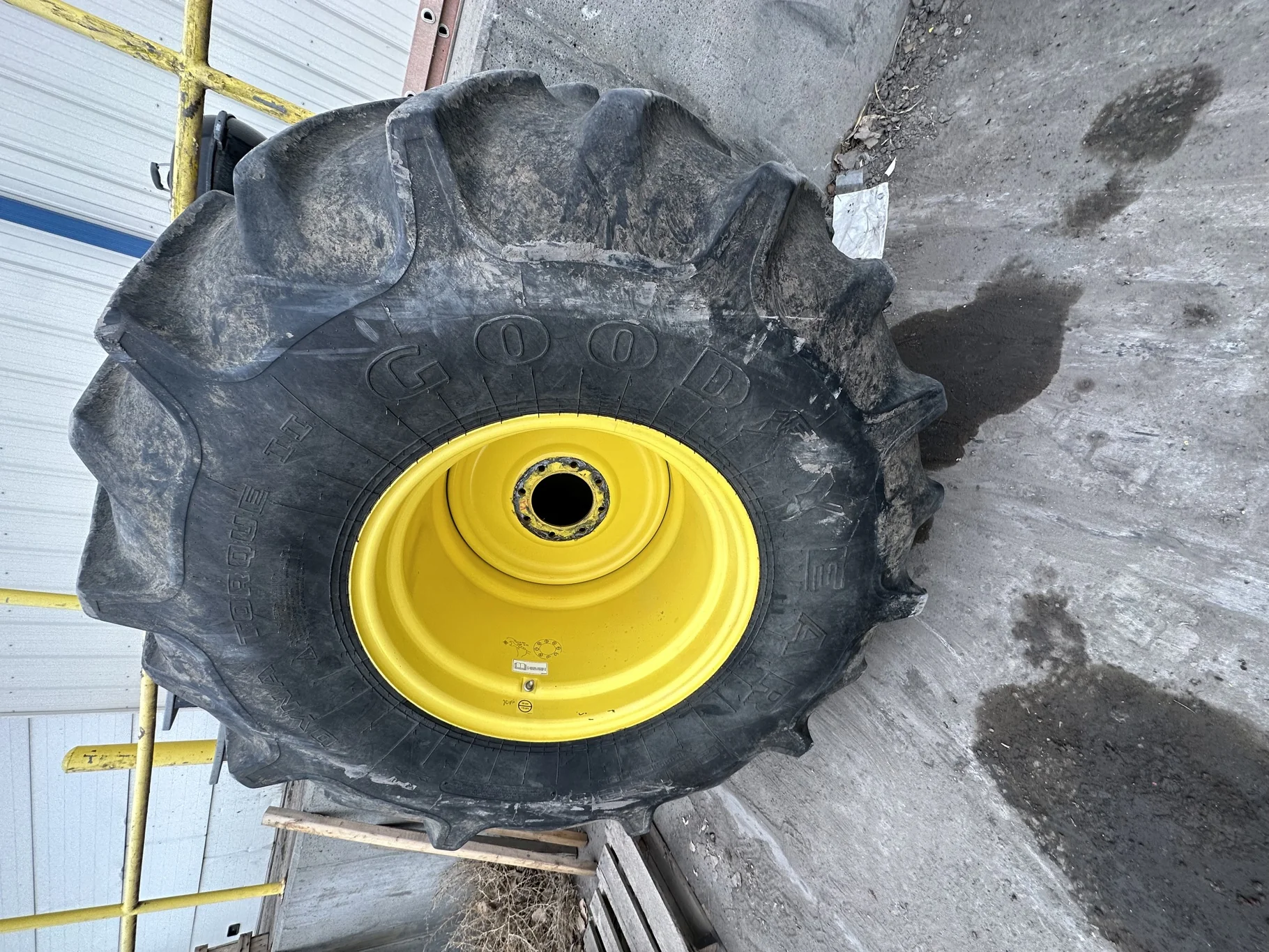 Used 63% 28L-26 Goodyear Dyna Torque II F(12Ply) R-1 TL on a 25 x 26 JD Yellow 8 Bolt Rear Com