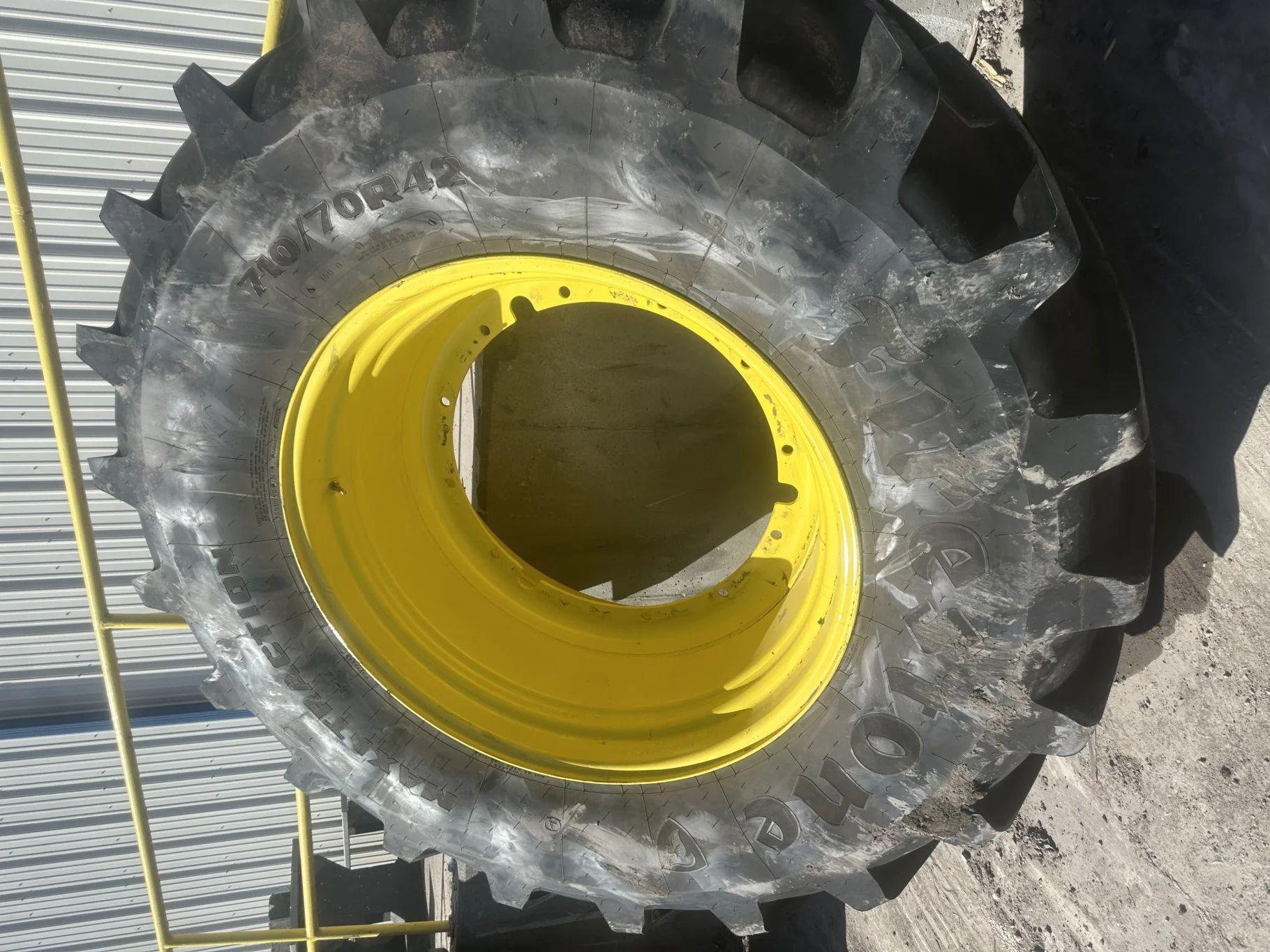 Used 95% 710/70R42 Firestone Maxi Traction R-1W (168D) TL on a 23 x 42 JD Yellow 12 Bolt Stub
