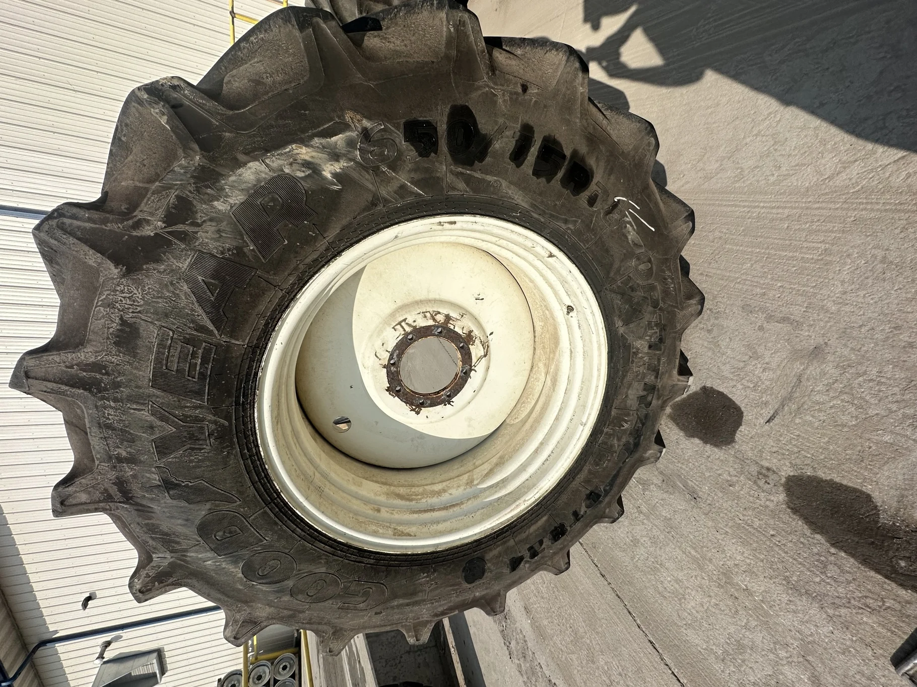 Used 90% 650/75R38 Goodyear Optitrac R-1W (169A8/B) TL on a 23 x 38 NH White 8 Bolt (.844) Sp