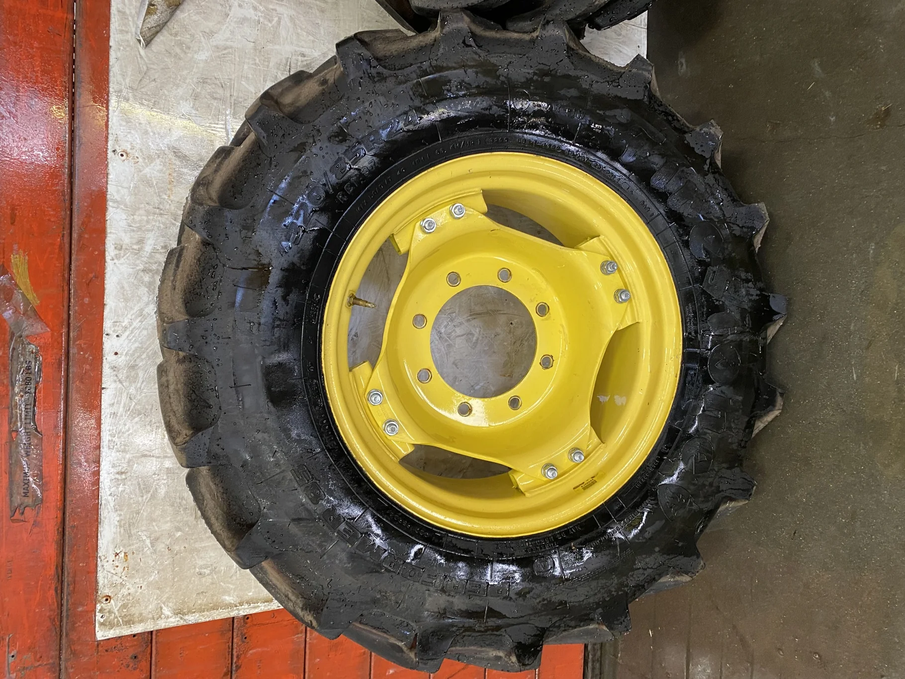 Used 85% 320/85R24 Firestone Performer 85 R-1W (122D) TL on a 10 x 24 John Deere Yellow 8 Bolt 6 Lo