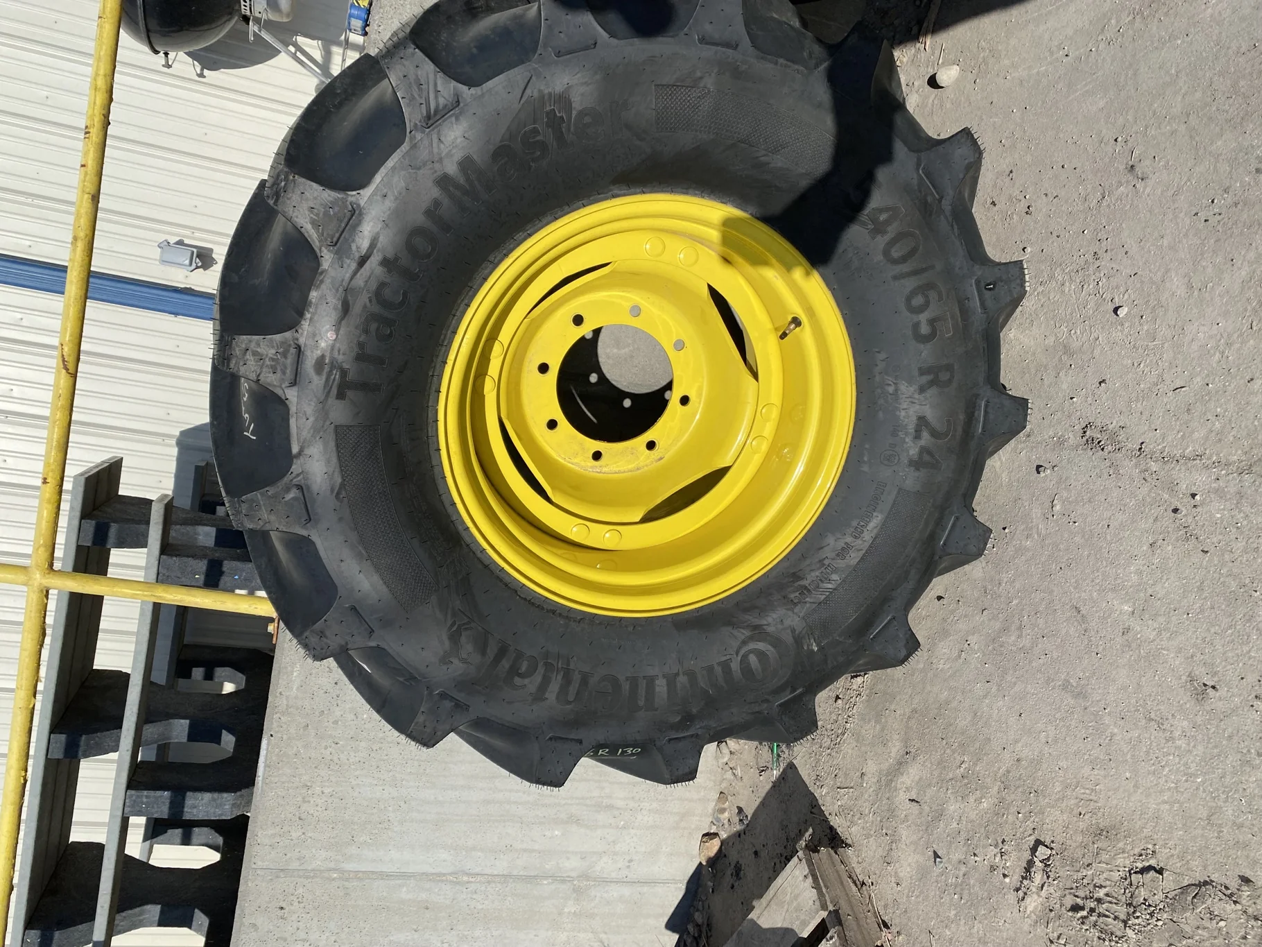 Used 98% 540/65R24 Continental TractorMaster R-1W 140D on a 16 x 24 JD Yellow 8 bolt wheel wit