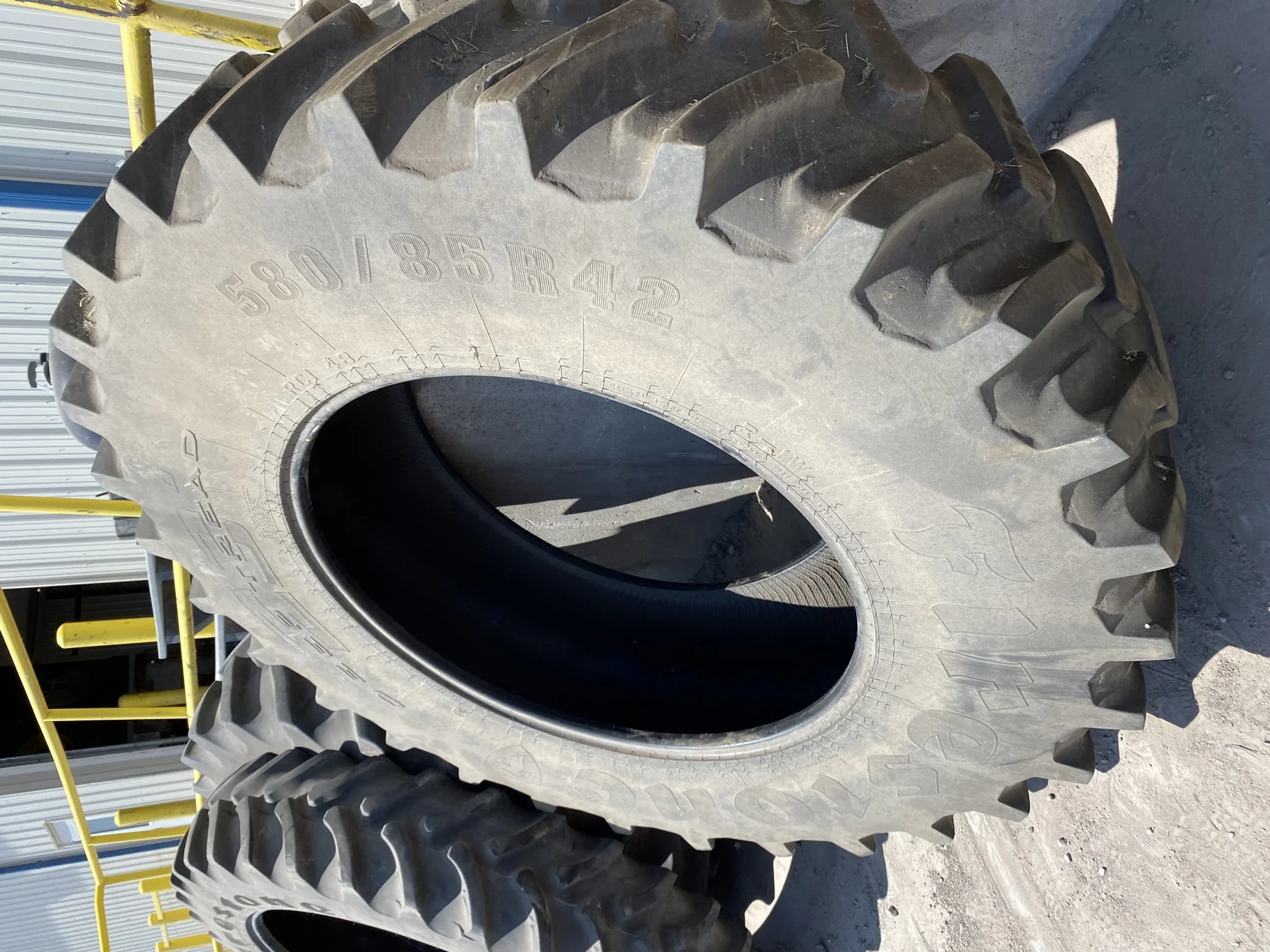 Used 75% 580/85R42 Firestone Radial Deep Tread 23 R-1W (166B) TL - Major Cut In Lug