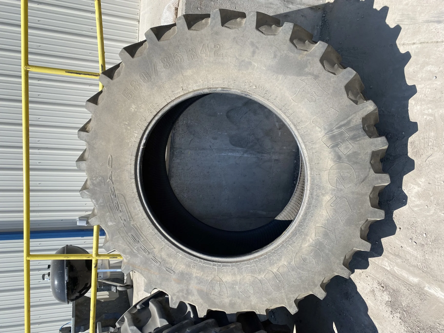 Used 75% 580/85R42 Firestone Radial Deep Tread 23 R-1W (166B) TL - Major Cut In Lug image 2