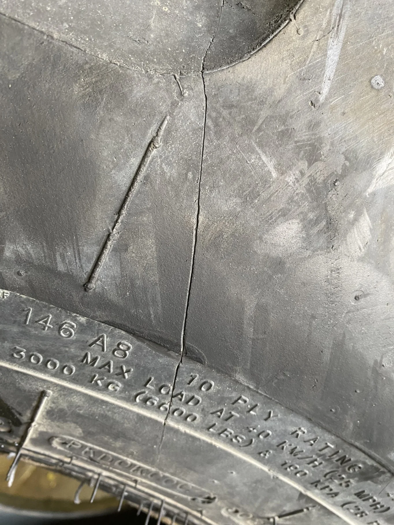 Used 75% 19.5L-24 Goodyear IT525 R-4 E(10Ply) TL (cuts in lugs, road wear, small chunks out of lugs image 3