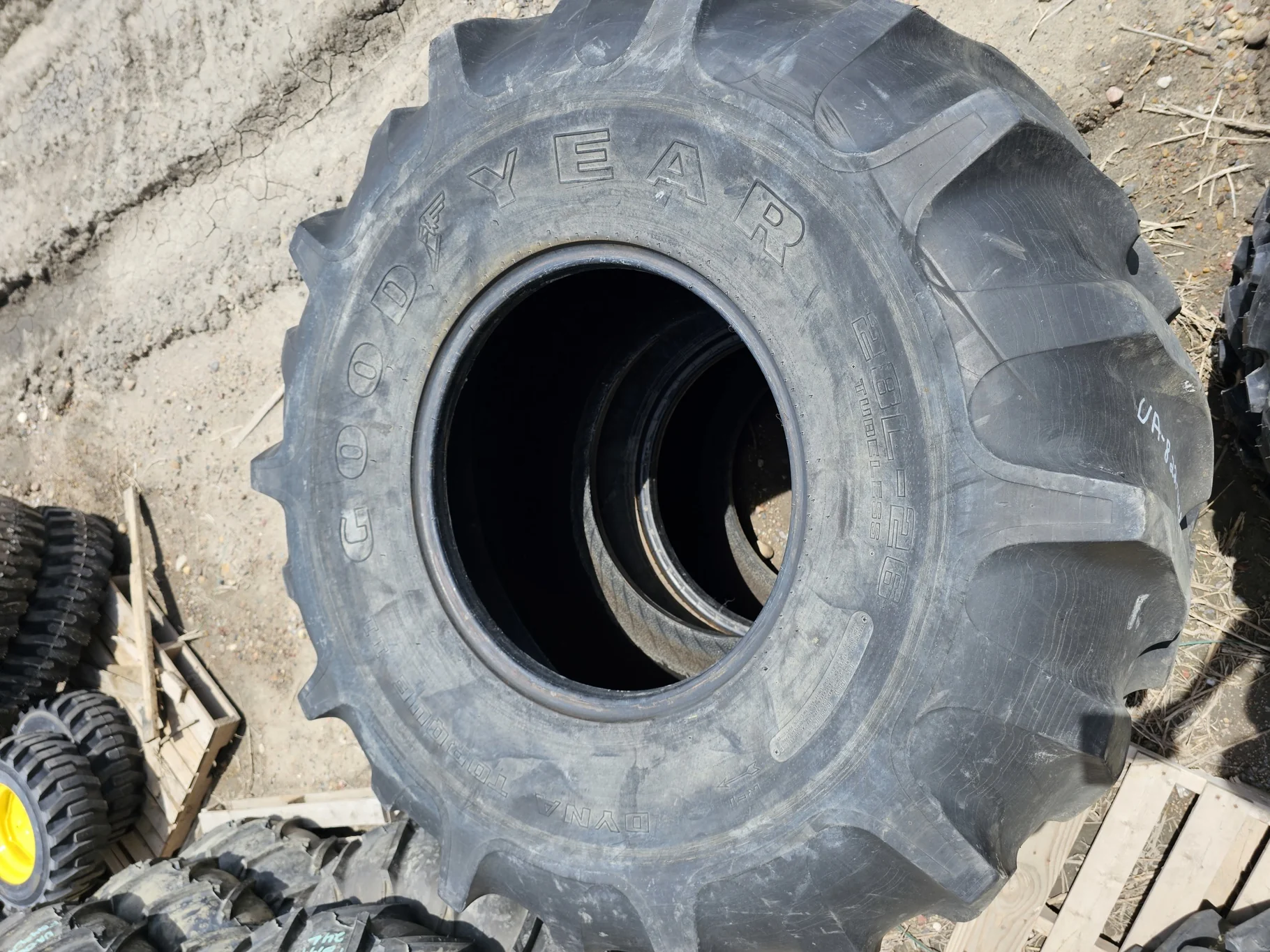 Used 55% 28L-26 Goodyear Dyna Torque II F(12Ply) R-1 TL (Stubble, Lug Cuts, Cuts Between Lugs
