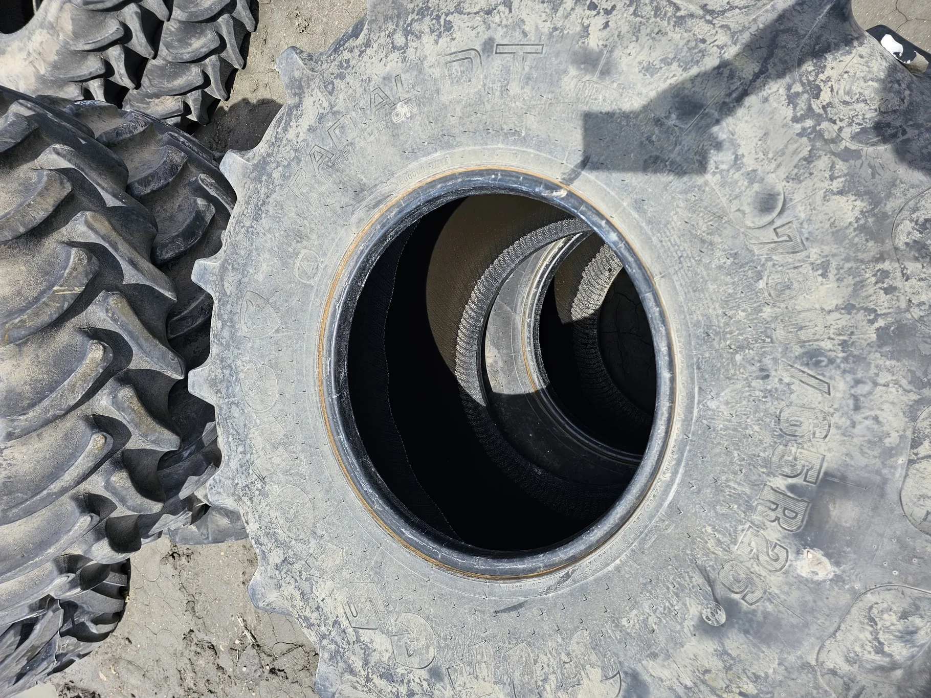 Used 70% 750/65R26 Firestone Radial All Traction DT R-1W (169B) TL (Stubble, Lug Cuts, Uneven Tread