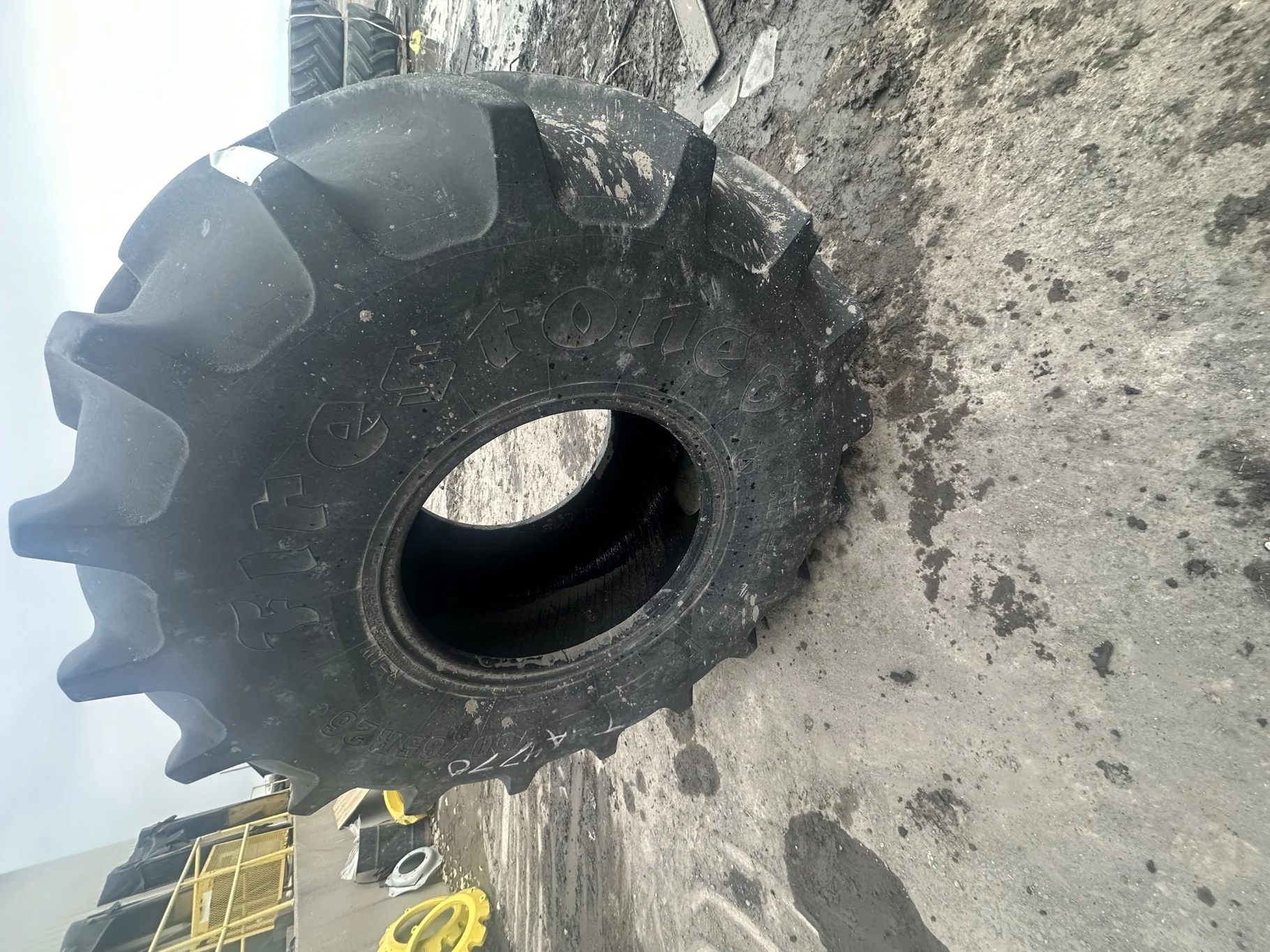Used 75% 750/65R26 Firestone Radial All Traction DT R-1W 169B TL (Stubble, Uneven Tread Wear, Cuts I