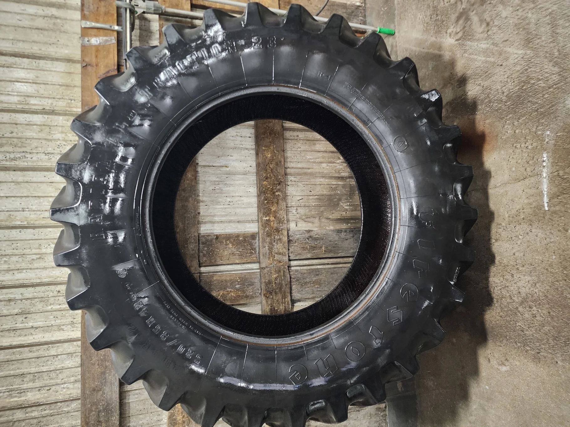 Used 75% 520/85R42 Firestone Radial Deep Tread 23 R-1W (157B) TL (Lug Cuts, Stubble, Weathering, Sc