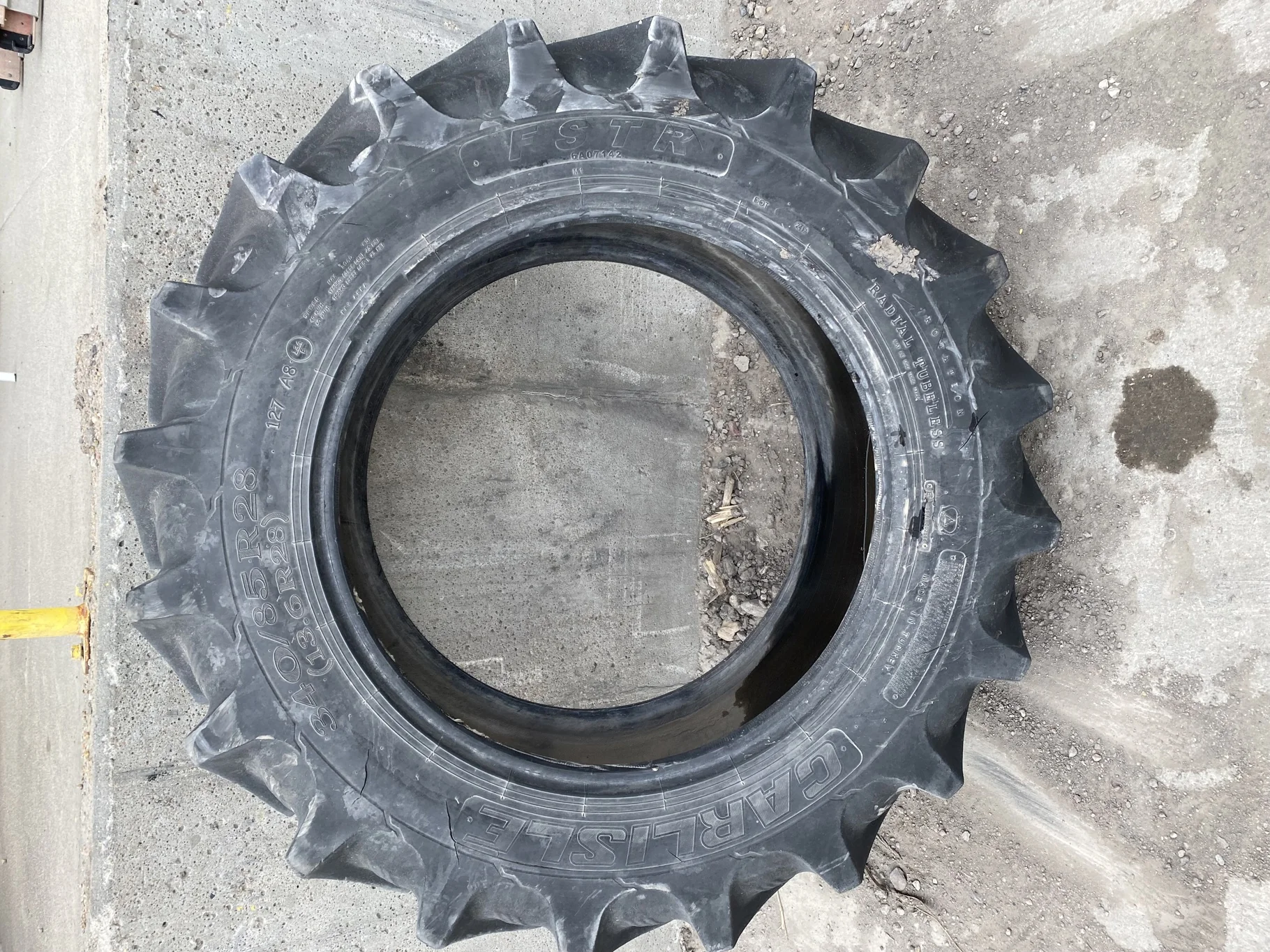 Used 70% 340/85R28 Carlise FSTR 127A8 TL (sidewall cuts, wreathing, road wear, lug cuts)