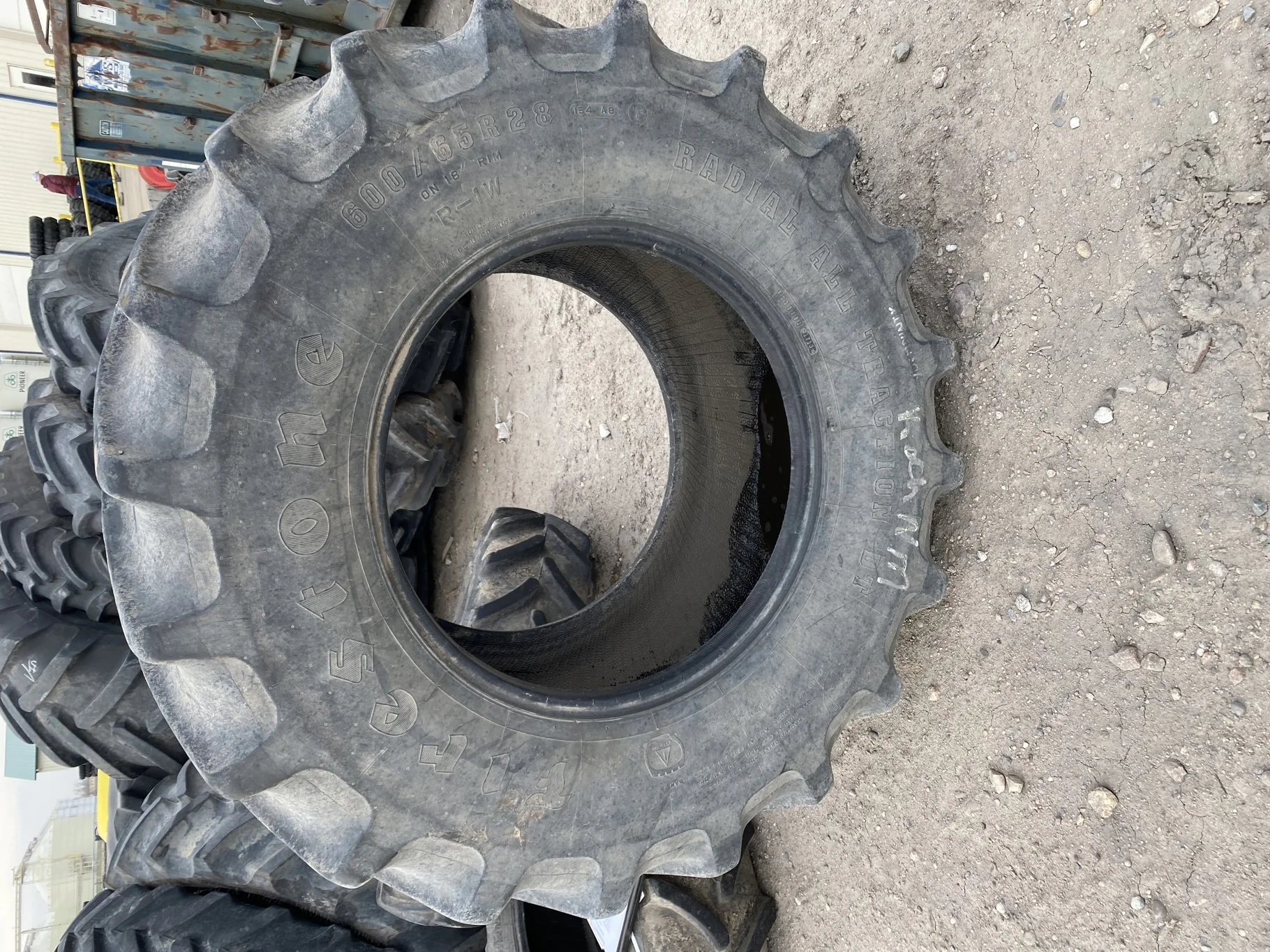 Used 66% 600/65R28 Firestone Radial All Traction DT 154A8 R-1W (Road wear, between tread cuts, sidew